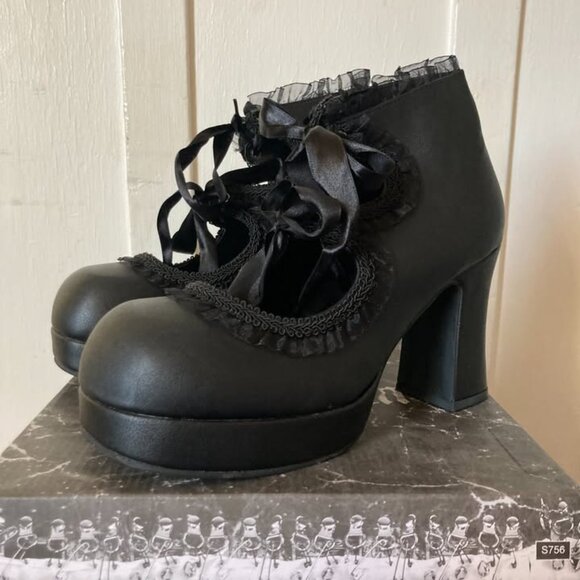 This is a pair of black platform high heels. - Picture 2 of 6